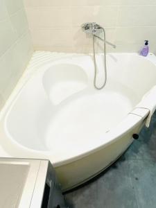 a white bath tub with a shower in a bathroom at Premium Rent in Kiev Centre - Kiev in Kyiv