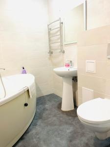 a bathroom with a toilet and a sink and a tub at Premium Rent in Kiev Centre - Kiev in Kyiv