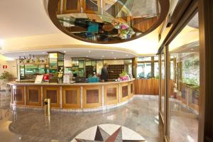 a restaurant with a bar in a building at Hotel Excelsior in Monfalcone