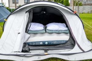 an open tent with two beds in it at KempingZator Namioty in Zator