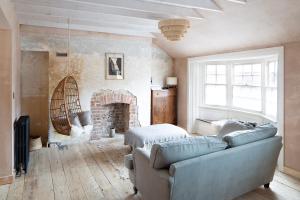 a living room with a couch and a fireplace at The Margate Galley in Kent