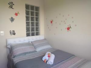 um quarto com uma cama com duas bonecas em Home Office Curitiba/vaga de estacionamento grátis em Curitiba