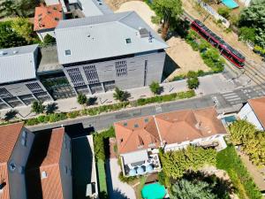 an overhead view of a building with a train at B&B "Clos Feuillat" in Lyon