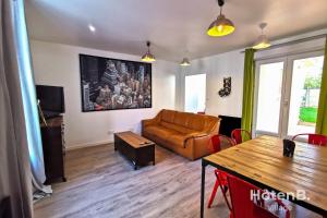 a living room with a couch and a table at CLIM Jolie maison de 60 m2 avec jardin in Limoges