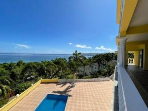 a view of the ocean from the balcony of a house at Spring Garden Mobay Resort Luxurious Apartments in Montego Bay
