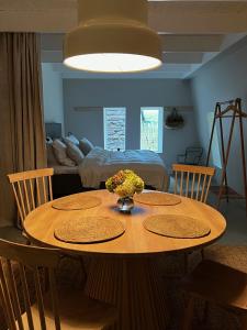 a dining room with a table with flowers on it at Two Bedroom, Newly Renovated, Garden Apartment in Gärsnäs, Österlen in Gärsnäs