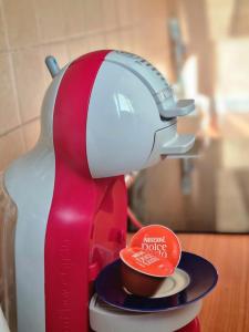 a red and white mixer sitting on top of a cup at Zafeiris Apartments in Livadia