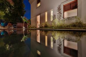 a house with a swimming pool at night at Estalagem Bonfim, 351 in Olinda