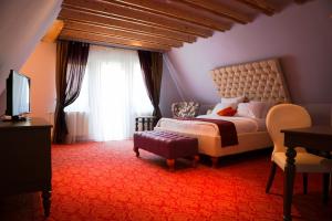 a bedroom with a bed and a large window at Oblique - Forest & Spa in Sinaia