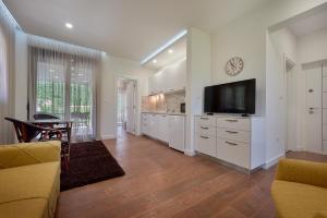 a living room with a flat screen tv on a wall at Georgiy Lux Apartments in Lastva
