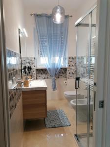 a bathroom with a shower and a sink and a toilet at Raggio di Sole in Gaeta