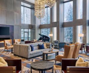 a living room with a couch and a piano at Grand Hyatt Vail Hotel Room With King Bed in Vail