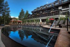 a swimming pool in front of a building at Grand Hyatt Vail Hotel Room With King Bed in Vail