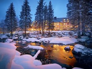 a river in front of a building in the snow at Grand Hyatt Vail Hotel Room With King Bed in Vail