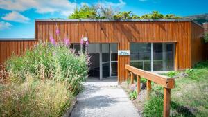 a building with a bench in front of it at Les Aliziers in Super Besse +9 photos