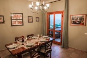 a dining room with a table with chairs and a window at Narni Charm in Narni