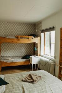 a bedroom with two bunk beds and a window at Turistgården Särna in Särna