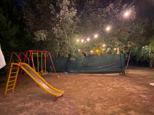 a playground with a slide in a park at night at Villa Laurus in Torre dell'Orso