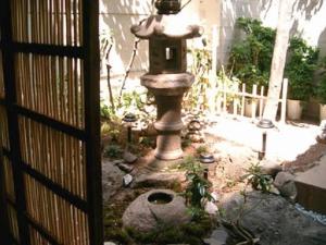 a fire hydrant in front of a stone wall at Daiya Ryokan in Kyoto