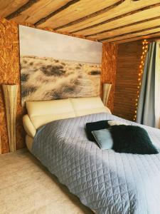 a bedroom with a bed with a black blanket at Sea Side Kaltene in Kaltene