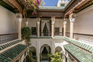 an indoor courtyard of a building with green tiles at Riad Safar in Marrakesh