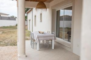 a white table and chairs on a patio at Casa Mat'Yse in La Bruguière