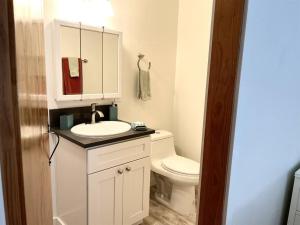 a bathroom with a white toilet and a sink at Cute 1 bedroom Ohana 10 miles from Eugene in Creswell