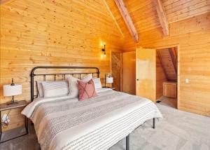 - une chambre avec un lit dans une cabane en bois dans l'établissement Large Elegant Reunion Cabin by Lake and Ski Resort, à Panguitch