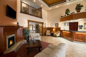 a living room with a couch and a fireplace at Super 8 by Wyndham Fort Nelson BC in Fort Nelson