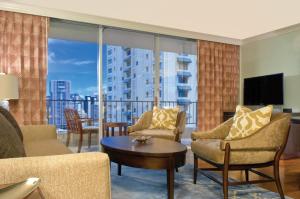 a living room with a couch and chairs and a large window at Wyndham Vacation Resorts Royal Garden at Waikiki in Honolulu