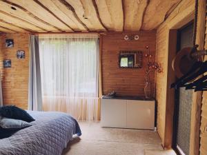 a bedroom with a bed and a window and a television at Sea Side Kaltene in Kaltene