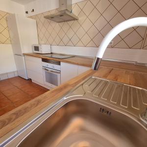 a kitchen with a stainless steel sink in a kitchen at Casa M de mar - Vistas 180º in Corralejo