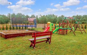 a park with a playground with benches and a slide at Nice Home In Bialogra With Wifi in Białogóra