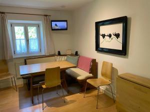 a dining room with a wooden table and chairs at Ferienwohnung Wagnerhaus in Bad Reichenhall