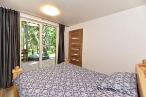 a bedroom with a bed and a sliding glass door at Forest relax 