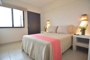 a bedroom with a large bed and a window at Hotel Coral Cuernavaca Resort & Spa in Temixco