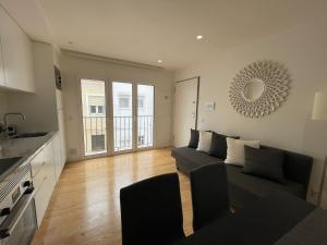 a living room with a couch and a table at Lux Life Properties in Nazaré
