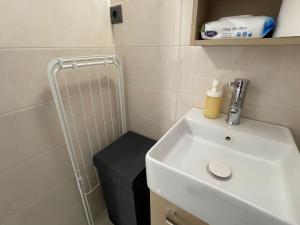 a bathroom with a sink and a stool next to a shower at Our little 1 in Athens