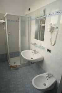 a bathroom with a sink and a shower at Hotel Meuble' Atlantic in Treviglio