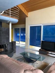 ein Wohnzimmer mit einem Sofa und einem Glastisch in der Unterkunft BluVilla in Malvaglia
