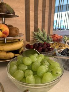 a bowl of grapes and other fruits on a table at MAR60 Apartments in Caorle