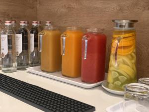a bunch of jars of juice on a desk at MAR60 Apartments in Caorle