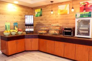 a fast food counter with bowls of fruit on it at Quality Inn Miami Airport - Doral in Miami