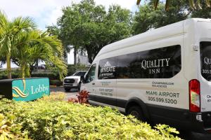 a white van parked in a parking lot at Quality Inn Miami Airport - Doral in Miami