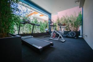 a room with a gym with a treadmill and a bike at MAR60 Apartments in Caorle