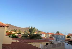 a view of a city with palm trees and buildings at Casa vacacional Renacer in Gran Tarajal