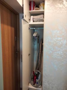 a bathroom with a closet with a hose in it at Apartamenty Tercet, Apartament Sonata in Ustka