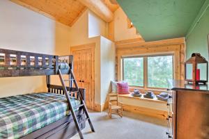a bedroom with a bunk bed and a window at 22STR-00506 Fairplay Log Cabin 26 Mi to Breck! in Fairplay
