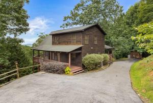 a large wooden house with a driveway at Large Cabin with views of Beautiful NC Mountains in Murphy