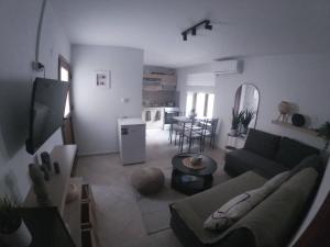 a living room with a couch and a table at Hara's Apartments in Prinos